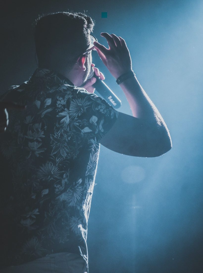 back-view-of-a-man-performing-on-stage-e1645336712995.jpg back-view-of-a-man-performing-on-stage-e1645336712995.jpg